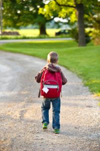 Child walking with a backpack