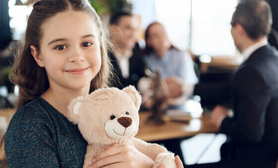 Smiling child holding a teddy bear